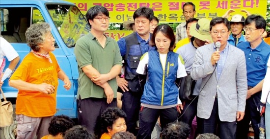 21일 윤상직 산업통상자원부 장관이 경남 밀양시 부북면 평밭마을을 방문해 송전탑 건설에 반대하며 농성을 벌이고 있는 주민들에게 정부 계획과 보상대책 등을 설명하고 있다. /연합뉴스 