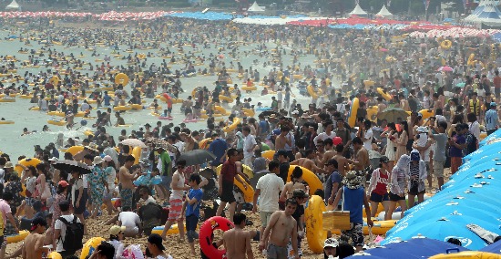8월 첫 휴일이면서 찜통더위가 계속된 4일 부산 해운대해수욕장에서 피서객들이 물놀이를 즐기며 더위를 식히고 있다. 3일에는 올 여름들어 가장 많은 80만명의 피서객들이 몰려 피서의 절정을 이뤘다.  