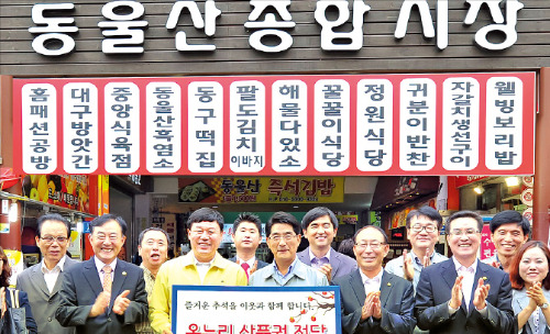 김종훈 울산 동구청장(앞줄 왼쪽 두 번째)과 김재훈 현대중공업 전무(세 번째)가 지난 12일 울산 전하동 동울산시장 입구에서 전통시장 상품권 전달식을 갖고 있다. 현대중공업 제공