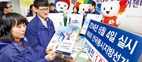 서울시 선거관리위원회 직원들이 6·4 지방선거 D-100(24일)을 하루 앞둔 23일 날짜 알림판을 설치하고 선거 홍보 포스터를 검토하고 있다. 정동헌 기자 dhchung@hankyung.com