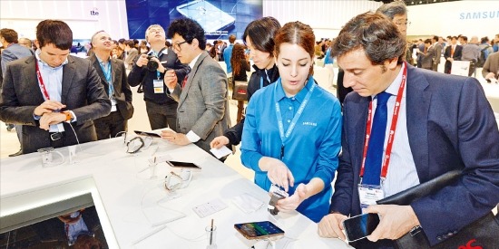 지난달 24~27일 스페인 바르셀로나에서 열린 ‘모바일월드콩그레스(MWC) 2014’의 삼성전자 전시장에서 관람객들이 제품을 이용해보고 있다. 사진공동취재단