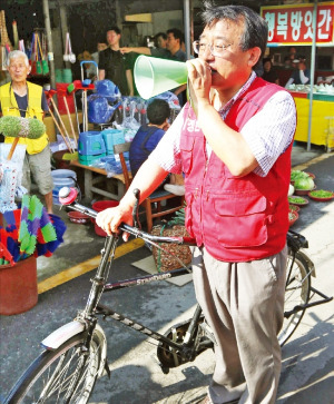 < 자전거 타고 당선 인사 > 전남 순천·곡성 국회의원 보궐선거에서 당선된 이정현 새누리당 의원이 31일 자전거를 이용해 순천시 역전시장을 돌며 확성기로 당선 인사를 하고 있다. 연합뉴스