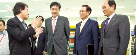 홍기택 산은금융지주 회장(왼쪽 두번째)이 자금을 지원해준 에이스테크놀로지를 방문해 현황을 듣고 있다. 산업은행 제공 