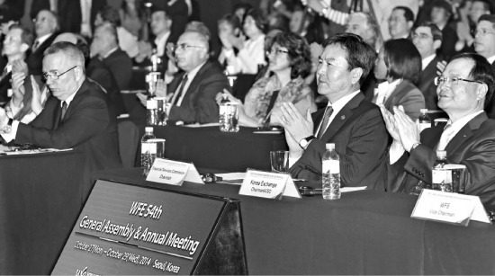 2014 세계거래소연맹(WFE) 총회에서 신제윤 금융위원장(오른쪽 두 번째)과 최경수 한국거래소 이사장(오른쪽) 등 참석자들이 박근혜 대통령의 영상 메시지를 보며 박수를 치고 있다. 정동헌 기자 dhchung@hankyung.com