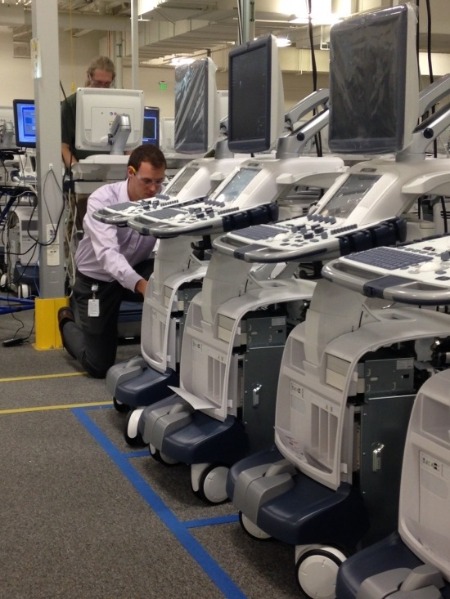 An employee at GE Healthcare’s ultrasound manufacturing floor in Milwaukee tests the performance of ultrasound devices