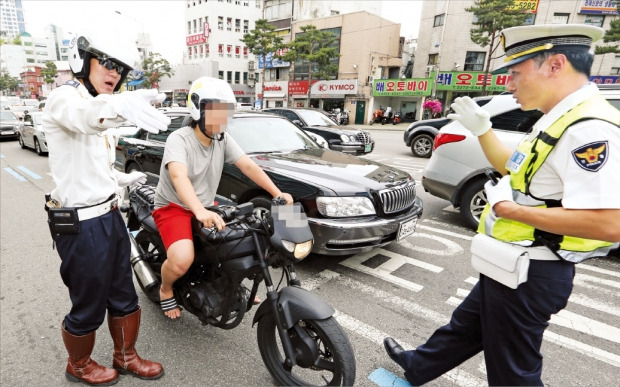 서울지방경찰청 소속 경찰관들이 서울 퇴계로 5가에서 불법으로 구조를 변경한 오토바이를 단속하고 있다. 연합뉴스