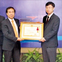 백인재 LS비나의 법인장(오른쪽)이 레단선 베트남 하이퐁 인민위원회 부위원장(왼쪽)으로부터 1급 노동훈장을 건네받고 있다.