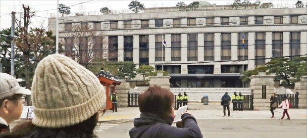 서울 재동 헌법재판소 앞을 지나던 관광객들이 사진을 찍고 있다. 박근혜 대통령 탄핵심판 사건을 심리하는 박한철 헌재소장과 상당수 헌법연구관은 18일 출근해 자료 검토와 법리 분석을 했다. 연합뉴스