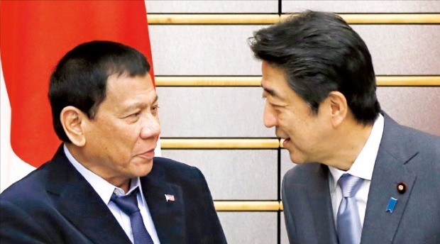 로드리고 두테르테 필리핀 대통령(왼쪽)과 아베 신조 일본 총리가 지난해 10월26일 정상회담을 위해 일본 도쿄 총리관저에서 만나 대화하고 있다. 도쿄AP연합뉴스