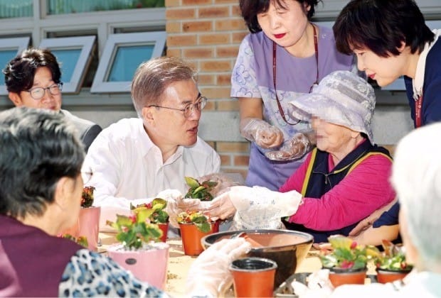 문재인 대통령이 2일 서울 세곡동 서울요양원을 방문해 치매 어르신들과 화분을 만들고 있다. 문 대통령은 환자 가족들과의 간담회에서 “치매 환자를 본인과 가족에게만 맡겨선 안 되고 국가와 사회가 함께 책임져야 한다”고 말했다. 문 대통령 뒤는 어머니가 치매를 앓고 있는 배우 박철민 씨. 강은구 기자 egkang@hankyung.com 