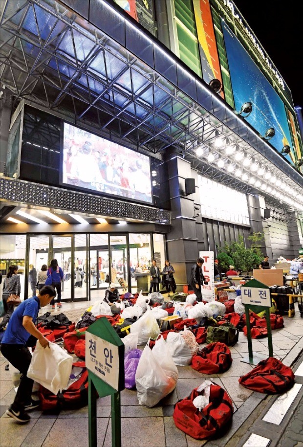 지난 27일 밤 서울 동대문 도매상가 누존 앞에 포장된 의류들이 쌓여 있다. 이곳에선 매일 온라인 쇼핑몰과 각 지역 소매상들이 전용 트럭을 대놓고 의류를 매입한다. 김범준 기자 bjk07@hankyung.com