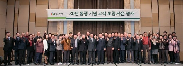 30년 동행기념 고객초청 사은행사에서 DB손해보험 임직원들과 30년 이상 연속으로 자동차보험을 가입한 고객들이 함께 기념촬영을 하고 있다.  