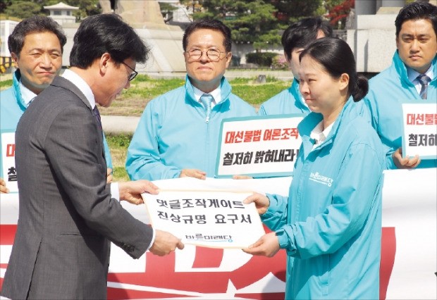 < 진상규명 요구하는 野 > 권은희 바른미래당 의원(오른쪽)이 18일 청와대 앞에서 진성준 정무기획비서관에게 ‘댓글조작게이트 진상규명요구서’를 전달하고 있다.  /연합뉴스 