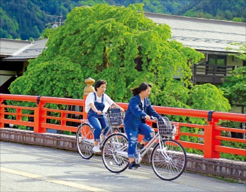 히다 후루카와 다리를 자전거로 건너는 소녀들. 