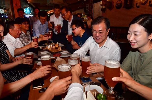  문재인 대통령이 26일 오후 서울 광화문 인근 한 맥줏집에서 퇴근길 시민들과 만나 건배하고 있다. 이 날 행사는 대통령 후보 시절 약속한 '퇴근길 국민과의 대화 일환'으로 열렸다. 대화 자리에는 박용만 대한상의회장과 청년 구직자, 경력단절 여성구직자. 최저임금 적용 근로자(아파트 경비원) 중소기업 대표, 편의점 점주, 서점, 음식점, 도시락업체 대표, 인근 직장인이 참석했다. 사진=연합뉴스