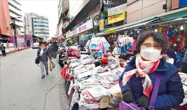 < 썰렁한 남대문 시장 > 서울지역 초미세먼지 농도가 2015년 공식 관측 이후 가장 높게 나타난 가운데 전통시장에도 사람들의 발길이 끊겼다. 5일 서울 중구 남대문시장 상인들이 마스크를 낀 채 손님을 기다리고 있다.    /신경훈  기자 khshin@hankyung.com 