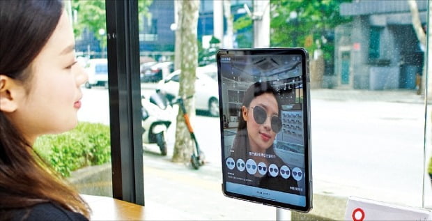 한 소비자가 이스트소프트의 증강현실(AR) 가상피팅 앱 ‘라운즈’를 활용해 가상으로 선글라스를 착용한 모습을 확인하고 있다.  /이스트소프트 제공