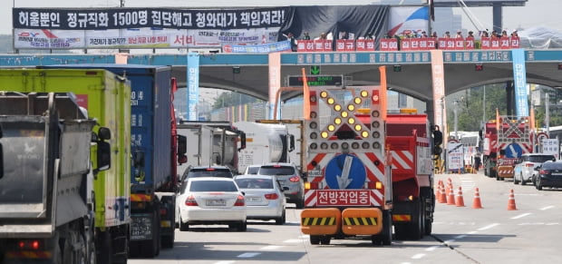 한국도로공사에 직접고용을 요구하며 시위를 이어온 요금수납원 노조원들이 4일 오전 경기도 성남시 경부고속도로 부산 방향 서울 톨게이트(TG) 진ㆍ출입로 구조물 위에서 고공시위를 벌이고 있다./김범준기자 bjk07@hankyung.com