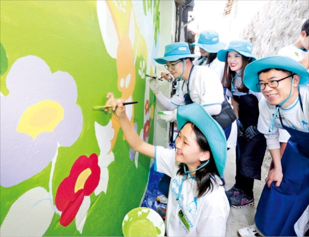 대우건설 임직원과 가족들이 벽화 그리기 봉사활동을 하고 있다.  /대우건설 제공