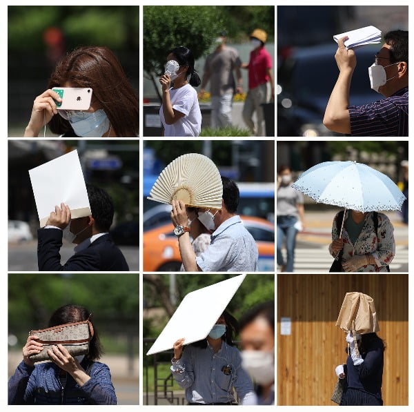 불볕더위가 이어진 11일 오후 서울 광화문광장 인근 거리에서 시민들이 가방, 양산, 부채, 서류봉투 등 여러 소지품으로 햇볕을 가리고 있다./사진=연합뉴스