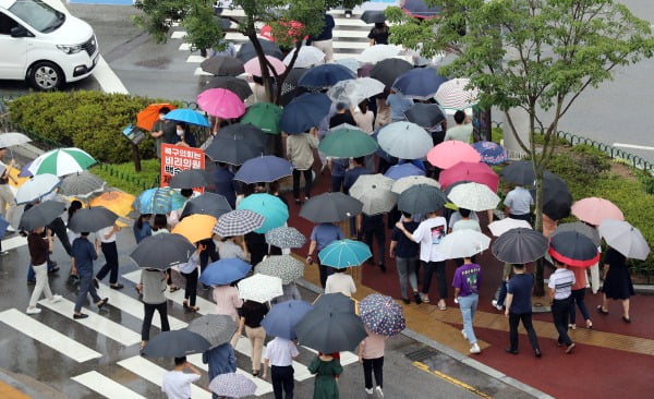 광주·전남에 많은 양의 비가 쏟아진 29일 오후 광주 북구청 앞 도로에 점심시간을 맞아 밖으로 나온 시민들이 우산을 쓰고 길을 건너고 있다/사진=연합뉴스