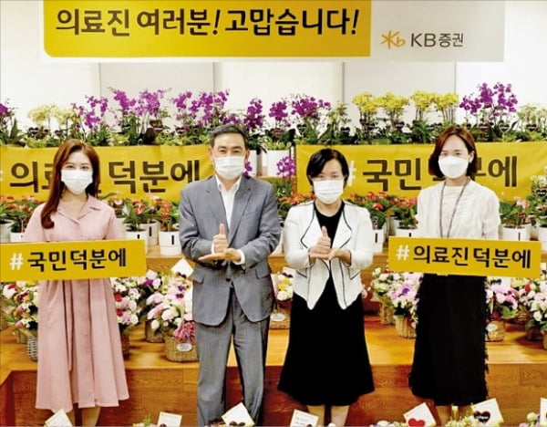 김성현 대표(왼쪽 두번째)와 박정림 대표(세번째)가 지난 6월 여의도 본사에서 코로나19 극복을 위한 ‘플라워 버킷 챌린지’와 ‘덕분에 챌린지’에 동참하며 기념사진을 촬영하고 있다.  KB증권 제공 
 