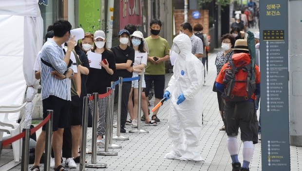 지난 16일 오전 서울 성북보건소 코로나19 선별진료소에서 시민들이 진담검사를 받기 위해 줄서 있다./김범준기자 bjk07@hankyung.com