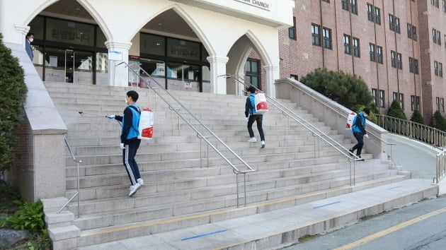 지구촌교회 관계자들이 수지성전 계단 입구를 방역하고 있다. [사진=지구촌교회 제공]