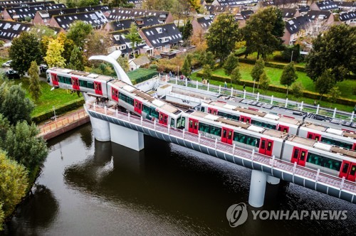 탈선 지상철 교묘하게 떠받친 고래 꼬리 조각상