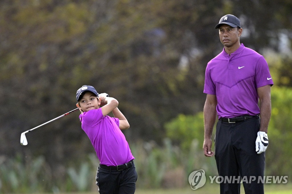 'Perfect Eagle', 11-year-old son Charlie, who looks like Woods, makes his dad laugh