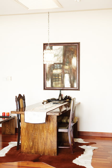 식탁 겸 책상. 낡은 듯한 가구와 그림, 그리고 빈티지 전등이 세련돼 보인다.