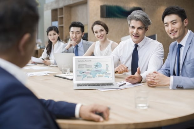 Chinese business people having meeting in board room