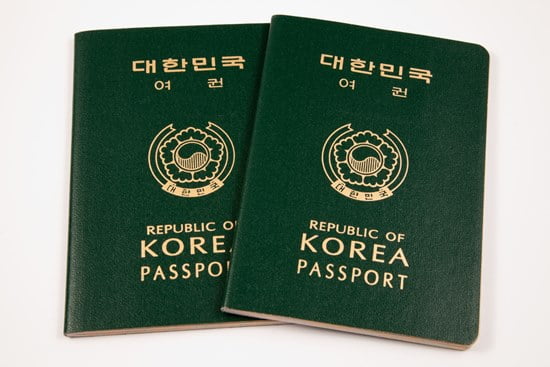 Two South Korean passports isolated on a white background.