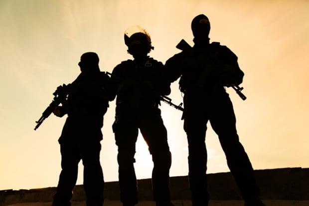 Silhouette of special forces operators with weapons