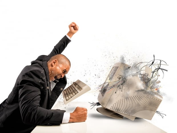 Businessman who breaks  furiously an old computer