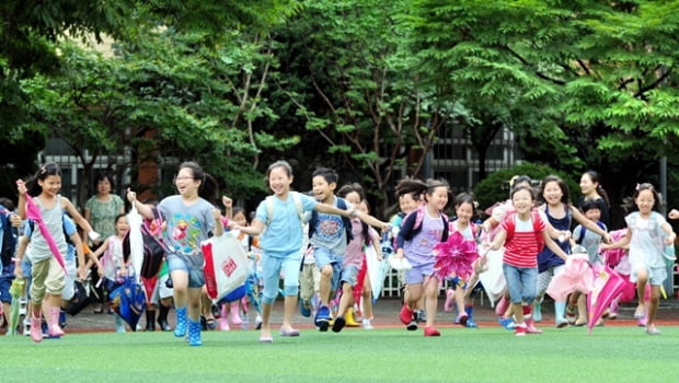 서울지역 일부 초등학교가 여름방학에 들어간 19일 서울 용산구 이촌동 신용산초등학교에서 2학년 학생들이 운동장을 가로질러 뛰어가며 집으로 향하고 있다. 
/허문찬기자  sweat@  20120719  