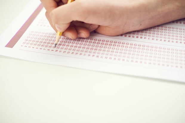 Hand of student choosing answers in bubble test sheet