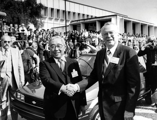 FILE - In this April 13, 1985 file photo, Toyota Motor Corp. Chairman Eiji Toyoda, left, and General Motors Corp. Chairman Roger B. Smith shake hands in front of a Chevrolet Nova as the new United Motor Manufacturing Inc., a $400 million joint venture between GM and Toyota, was inaugurated with a dedication ceremony at the Fremont, Calif., plant. Toyoda, a member of Toyota's founding family who helped create the super-efficient "Toyota Way" production method, has died. He was 100. The automaker said Toyoda, a cousin of the Japanese automaker's founder Kiichiro Toyoda, died Tuesday, Sept. 17, 2013 of heart failure at Toyota Memorial Hospital in Toyota, central Japan. (AP photo/Paul Sakuma, File)