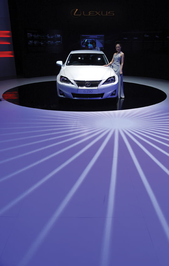 A model poses next to Japanese automaker Toyota Lexus IS 250 during a media tour at the Kuala Lumpur International Motor Show 2010 in Kuala Lumpur, Malaysia, Thursday, Dec. 2, 2010. More than 150 exhibitors from 15 countries participate in the Kuala Lumpur International Motor Show 2010 from Dec. 3-12. (AP Photo/Lai Seng Sin)