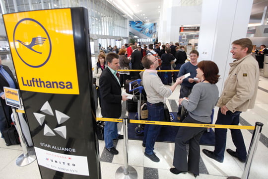 Passengers wait in line to check into a Lufthansa flight that is scheduled to leave for Europe from Philadelphia International Airport in Philadelphia, Monday, April 19, 2010. (AP Photo/Matt Rourke)