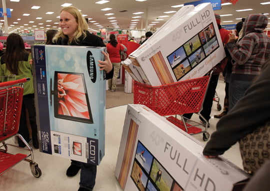 Early bird shoppers snatch up flat screen televisions at the Target store in Mayfield Hts., Ohio in the early hours of Friday, Nov. 25, 2011.  Black Friday began in earnest as Target, Abercrombie & Fitch and other stores opened their doors at midnight. (AP Photo/Amy Sancetta)