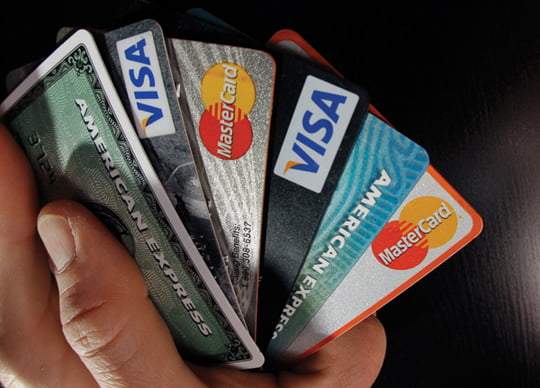 In this March 5, 2012 photo, consumer credit cards are posed in North Andover, Mass. Consumer borrowing rose by $17.8 billion in January, the Federal Reserve said Wednesday, March 7, 2012. That followed similar gains in December and November.    (AP Photo/Elise Amendola)