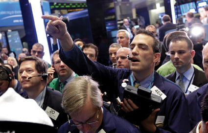 Trader Gregory Rowe calls out an order on the floor of the New York Stock Exchange Friday, April 19, 2013. The broad Standard & Poor's 500 index opened higher early Friday.  (AP Photo/Richard Drew)