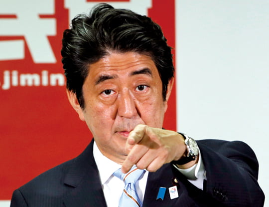 FILE - In this July 22, 2013 file photo, Japanese Prime Minister Shinzo Abe, president of the Liberal Democratic Party, points a reporter during a press conference in Tokyo. Japan's industrial output fell in June for the first time in five months, the government said Tuesday, July 30, 2013 as it released data highlighting the fragility of the recovery in the world's No. 3 economy. Abe has claimed progress with his "Abenomics" strategy of fighting deflation with aggressive monetary easing and strong government spending. But he has indicated he may consider amending the plan for a 3 percent increase, to 8 percent, next April. (AP Photo/Koji Sasahara, File)