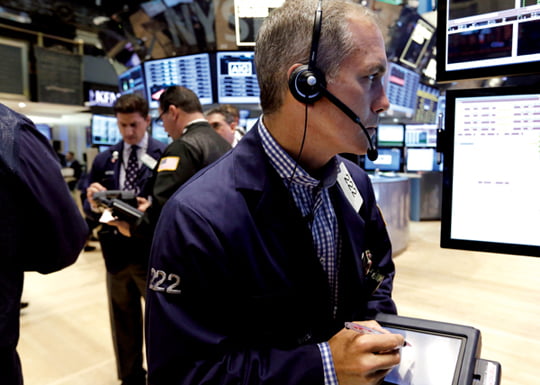 In this Friday, June 28, 2013, photo, Trader Timothy Nick, right, works on the floor of the New York Stock Exchange. Asian stock markets floundered Friday July 26, 2013 as China pressed ahead with industrial restructuring that is partly to blame for slowing growth in the world's No. 2 economy. (AP Photo/Richard Drew)