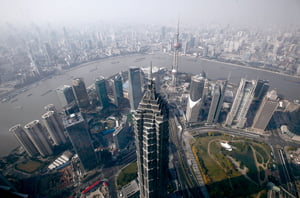 In this Dec. 7, 2010 photo, high-rise buildings are seen at the Pudong New Development Zone in Shanghai, China. The prolonged weakness in the U.S. and Europe may be the least of Asia's troubles in 2011, economists say, as the region fights potentially destabilizing inflationary pressures. (AP Photo/Eugene Hoshiko)
