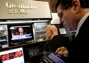 Goldman Sachs CFO David A. Viniar is watched on a television in the Goldman Sach booth on the floor of the New York Stock Exchange, Tuesday, April 27, 2010, in New York. Viniar is testifying before a Senate panel investigating Goldman's role in the financial crisis and the Securities and Exchange Commission fraud suit against it. (AP Photo/Richard Drew)
