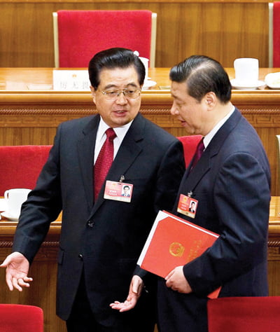 FILE - In this March 13, 2009 file photo, Chinese President Hu Jintao, left, chats with Vice President Xi Jinping as they leave the Great Hall of the People after the closing ceremony of the National People's Congress in Beijing, China. Chinese Vice President Xi has been promoted to vice chairman of a key Communist Party military committee, state media reported Monday, Oct. 18, 2010, in the clearest sign yet he is on track to be the country's future leader. (AP Photo/Andy Wong, File)