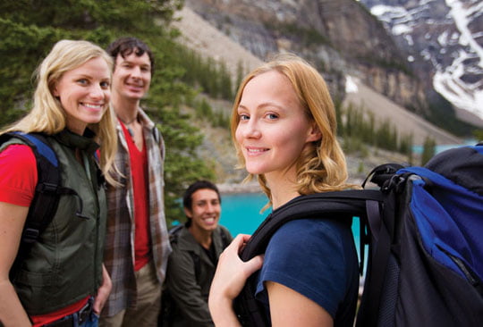 A group of friends hiking with a mountain landscape in the background