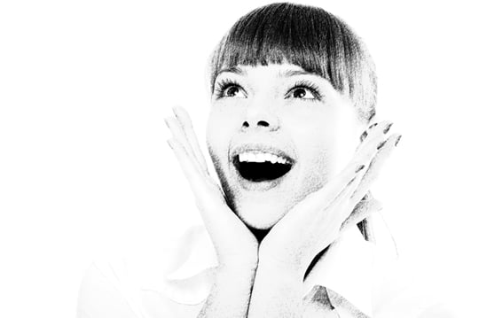 Surprised young woman, isolated on white background.